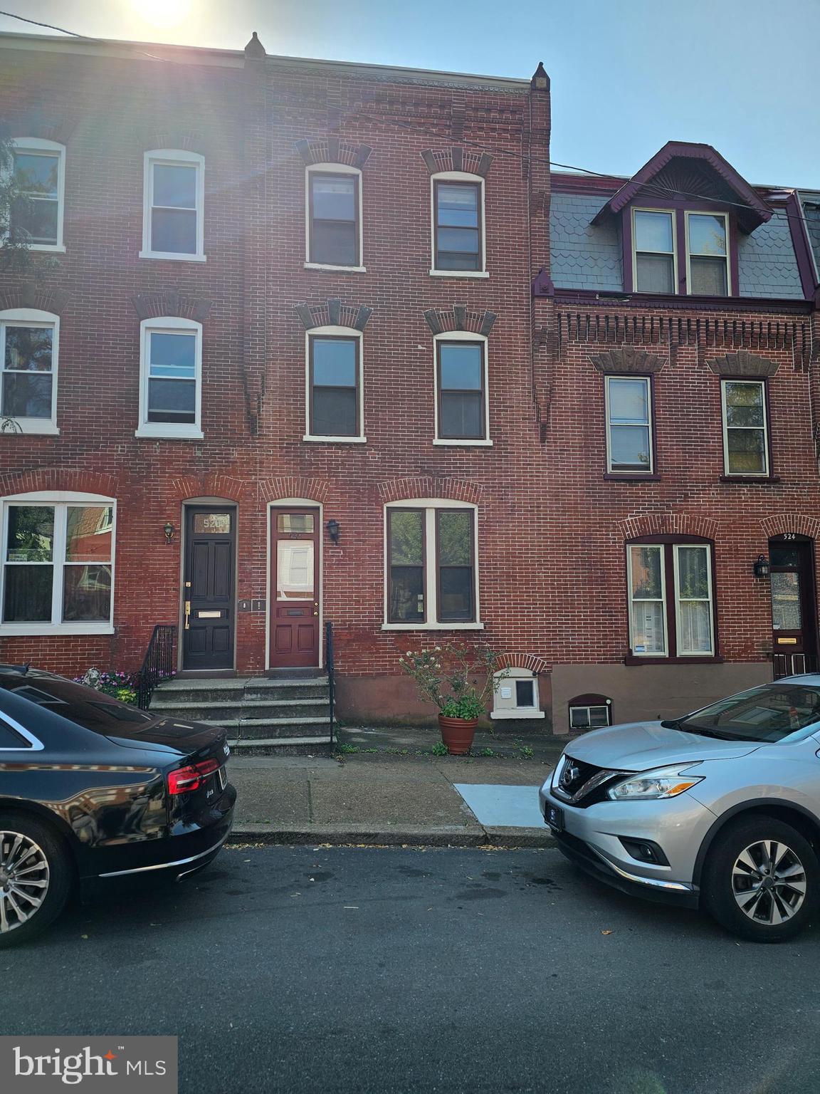 a front view of a house with parking space