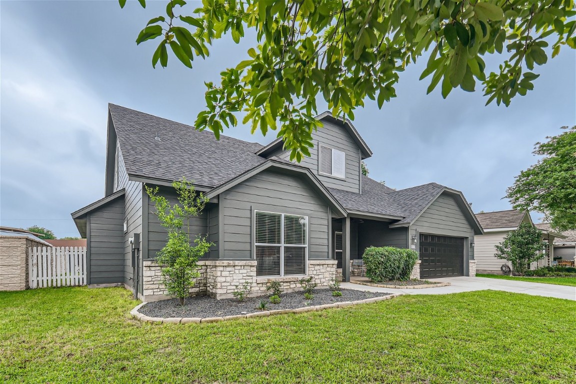 a front view of a house with a yard and porch