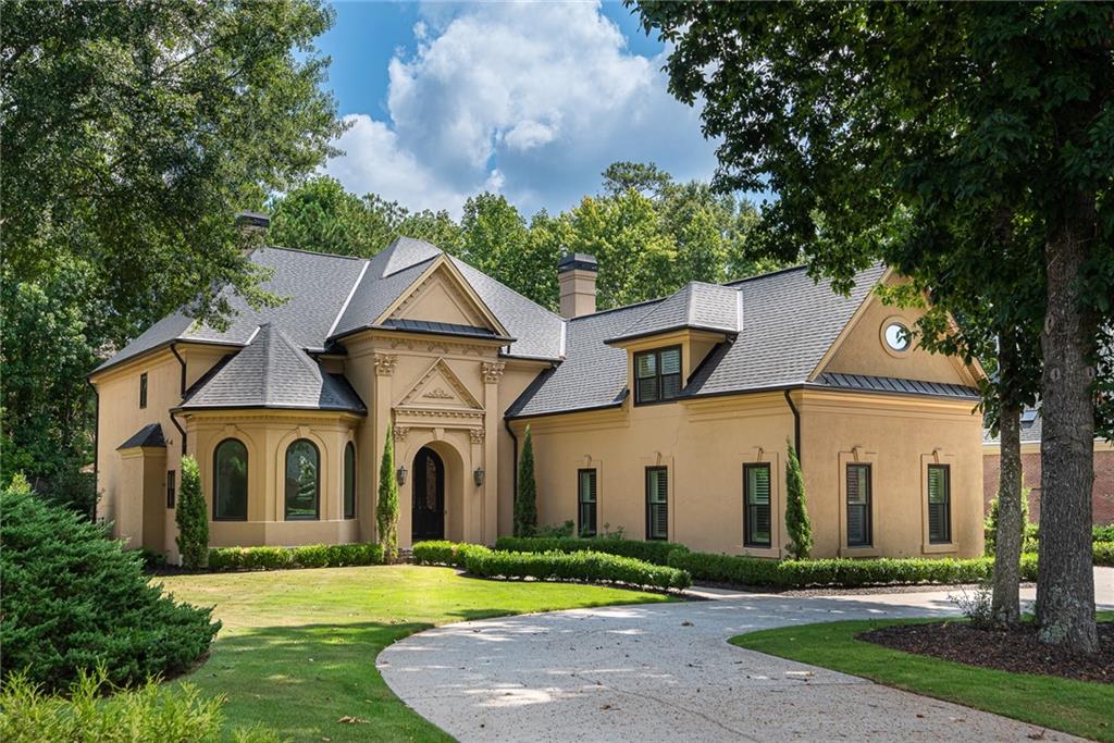 a front view of house with yard and green space