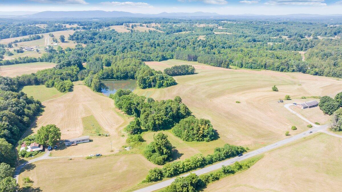 an aerial view of a house with a yard and lake view