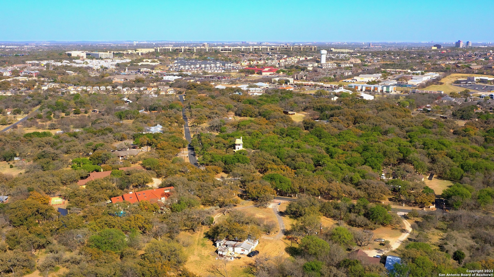 an aerial view of residential houses with city view