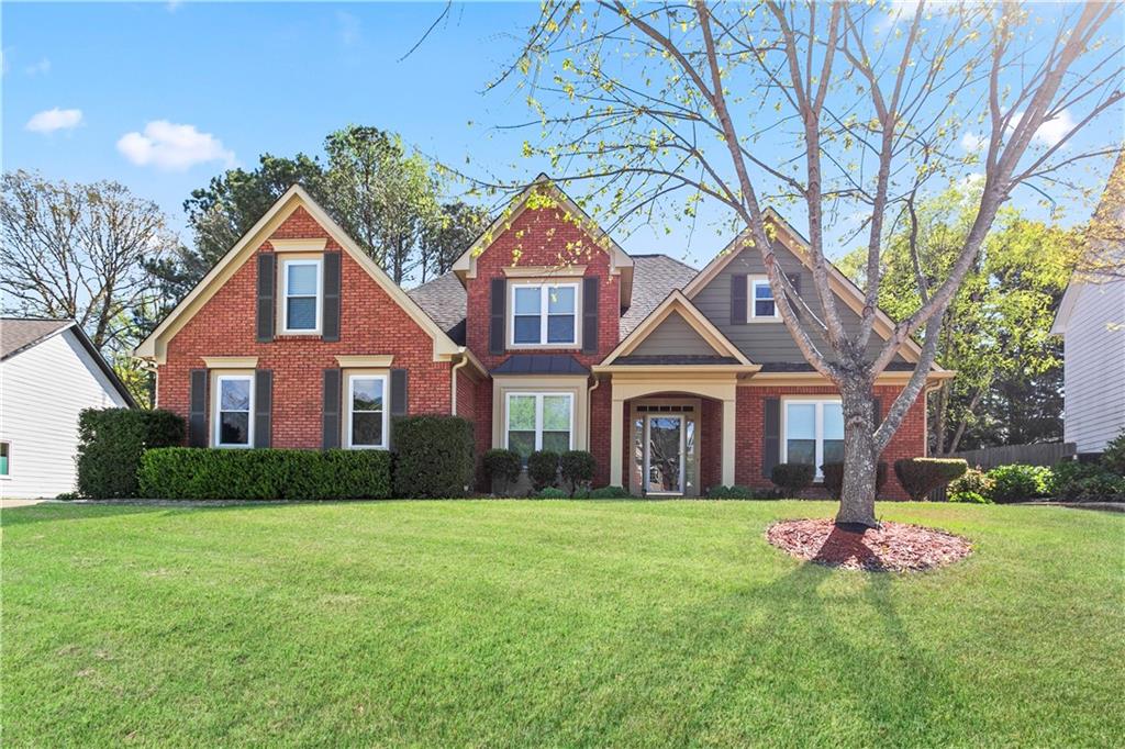 a front view of a house with a yard and garage