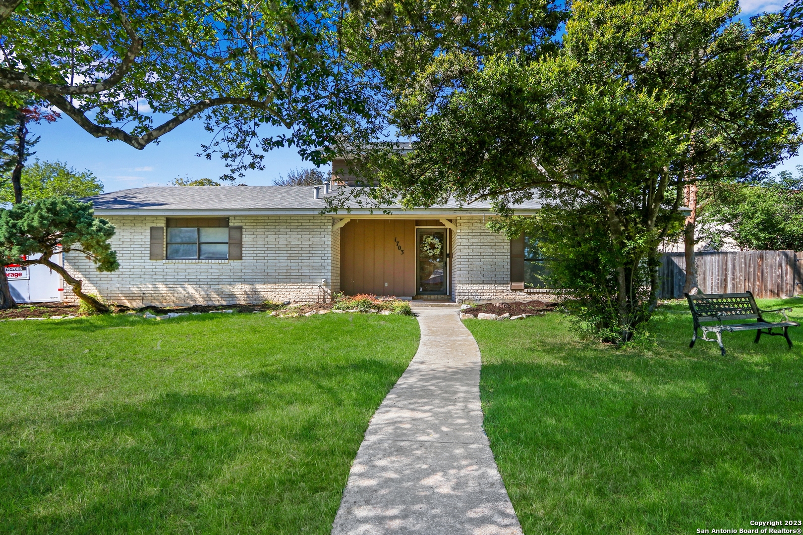 a front view of house with a garden