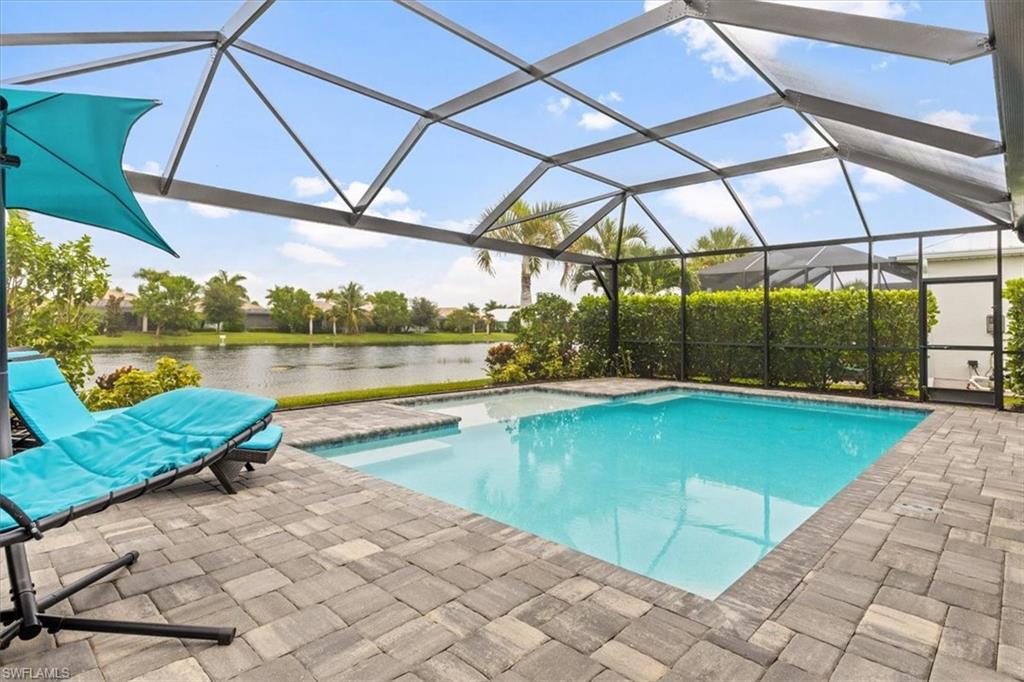 View of swimming pool with a lanai and a patio area