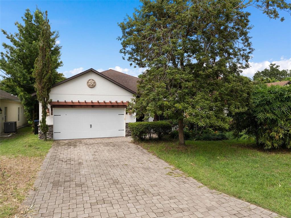 a front view of a house with a garden and yard