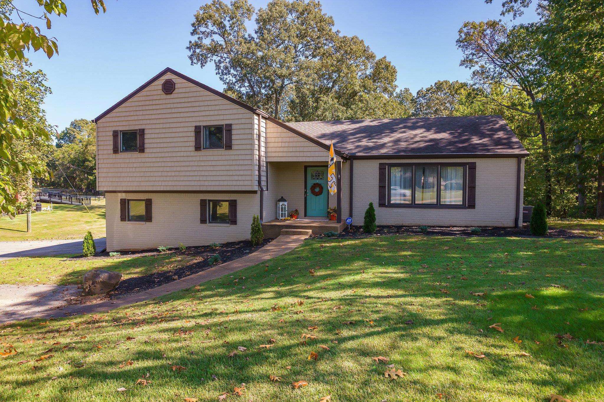 a view of a house with a yard patio and fire pit