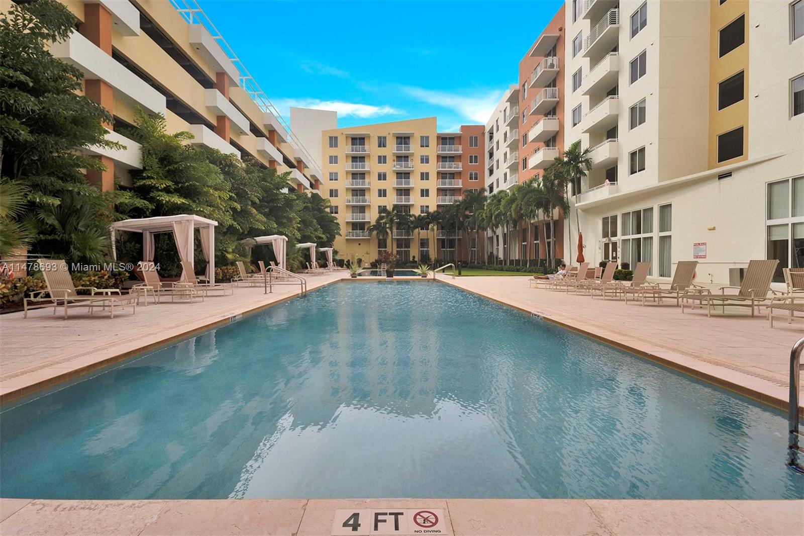 a view of a swimming pool with outdoor seating