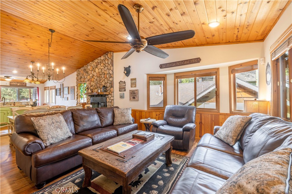 a living room with furniture a ceiling fan and a window