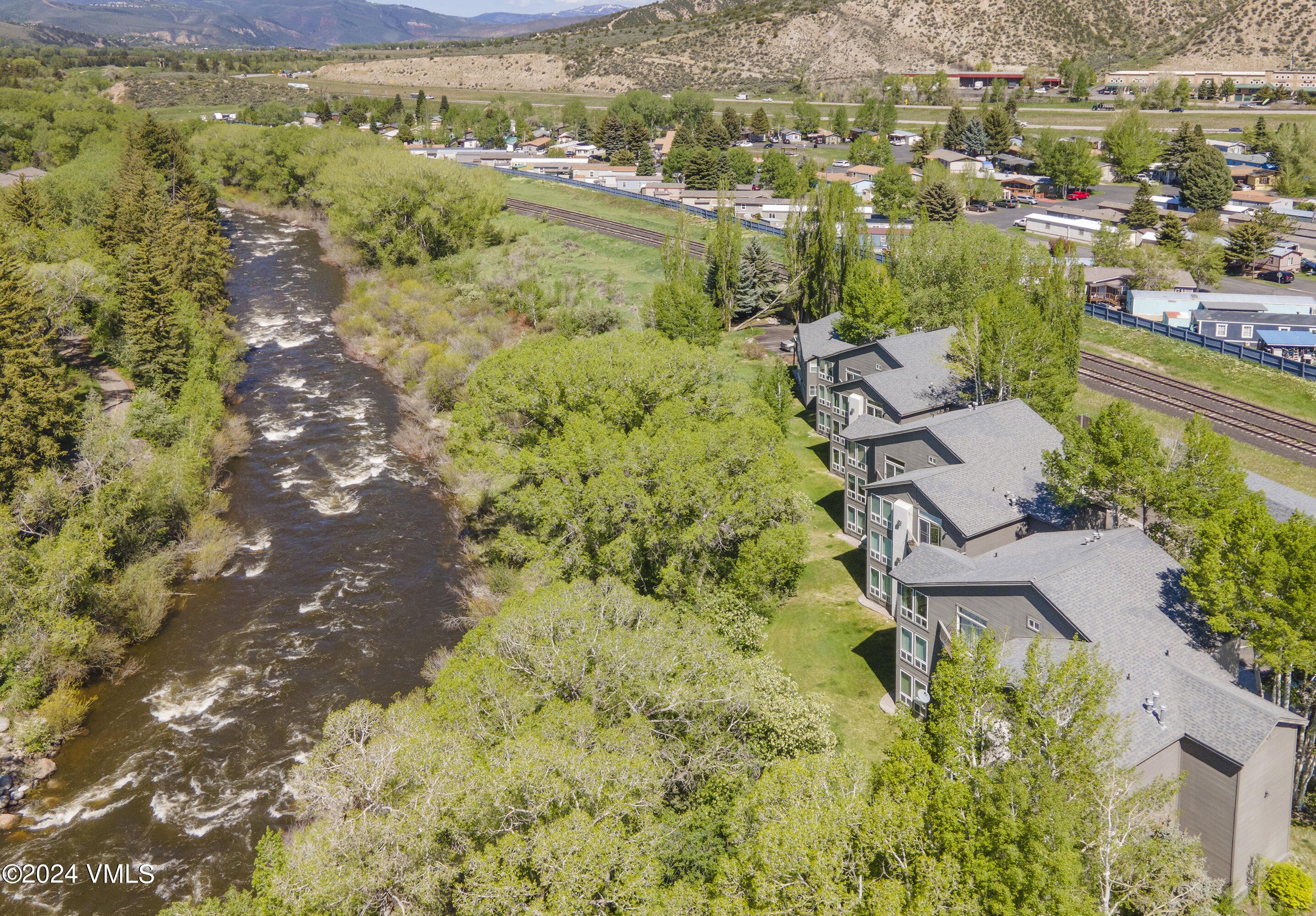 an aerial view of residential houses with outdoor space