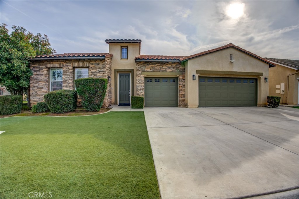 a front view of a house with a yard and garage