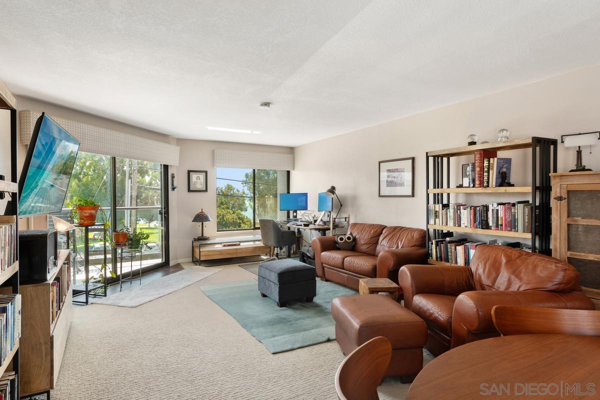 a living room with furniture and a book shelf