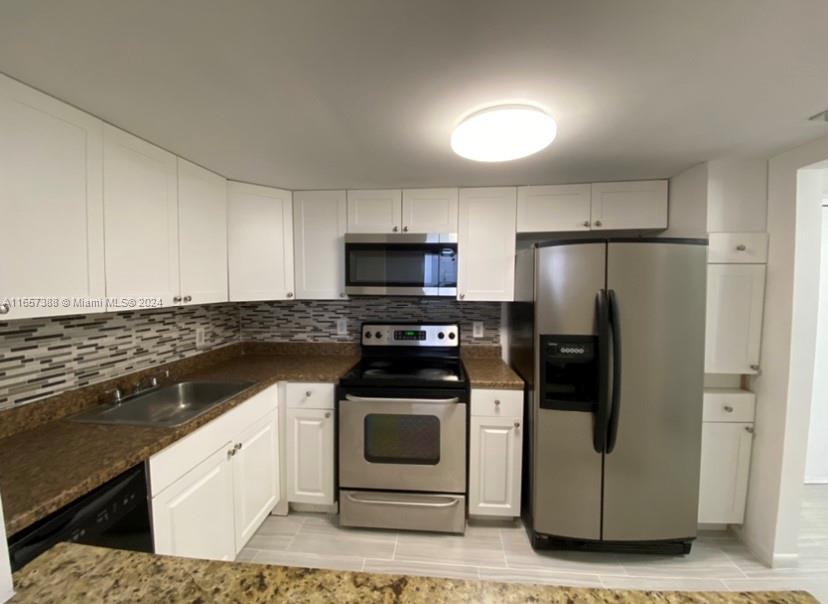 a kitchen with a stove and a refrigerator