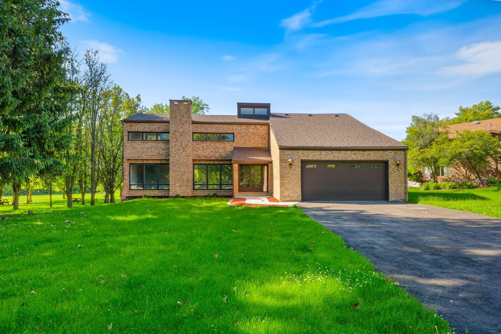 a view of an house with backyard and a garden