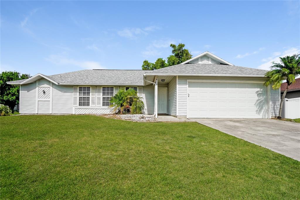 a front view of a house with a yard and garage