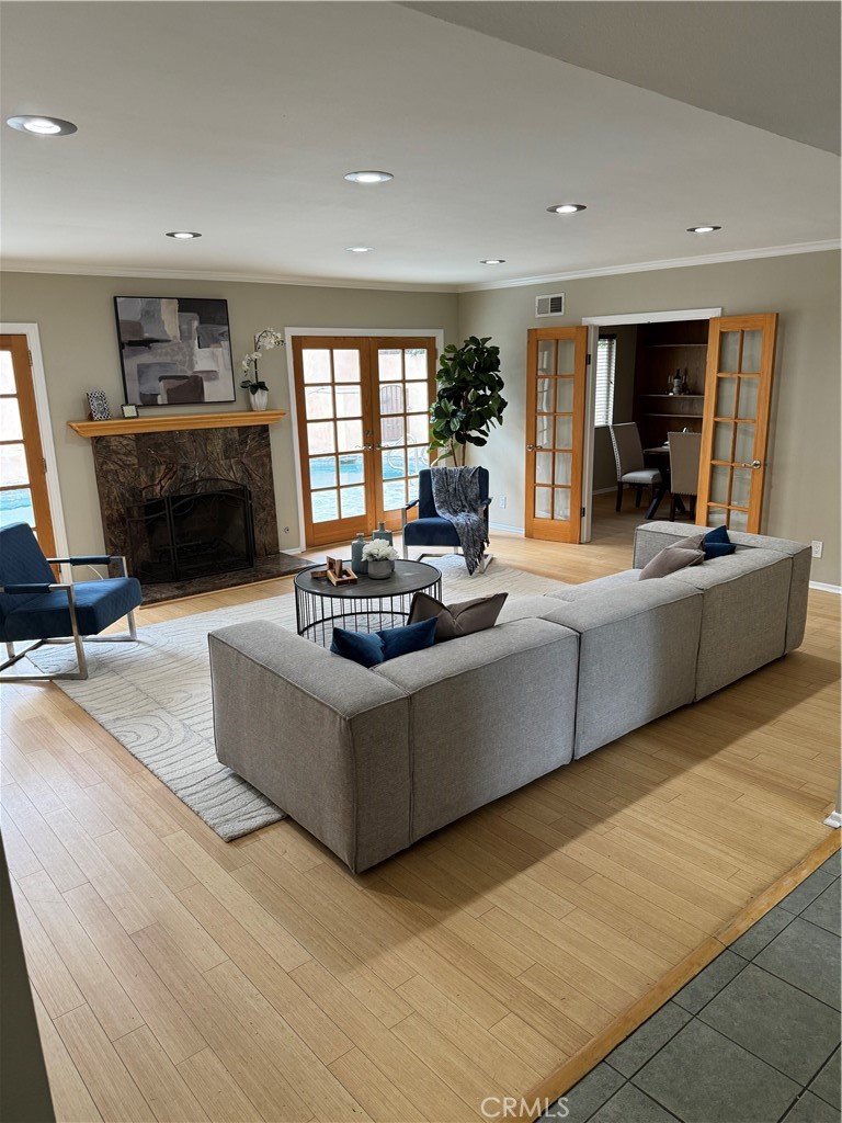 a living room with fireplace furniture and a large window