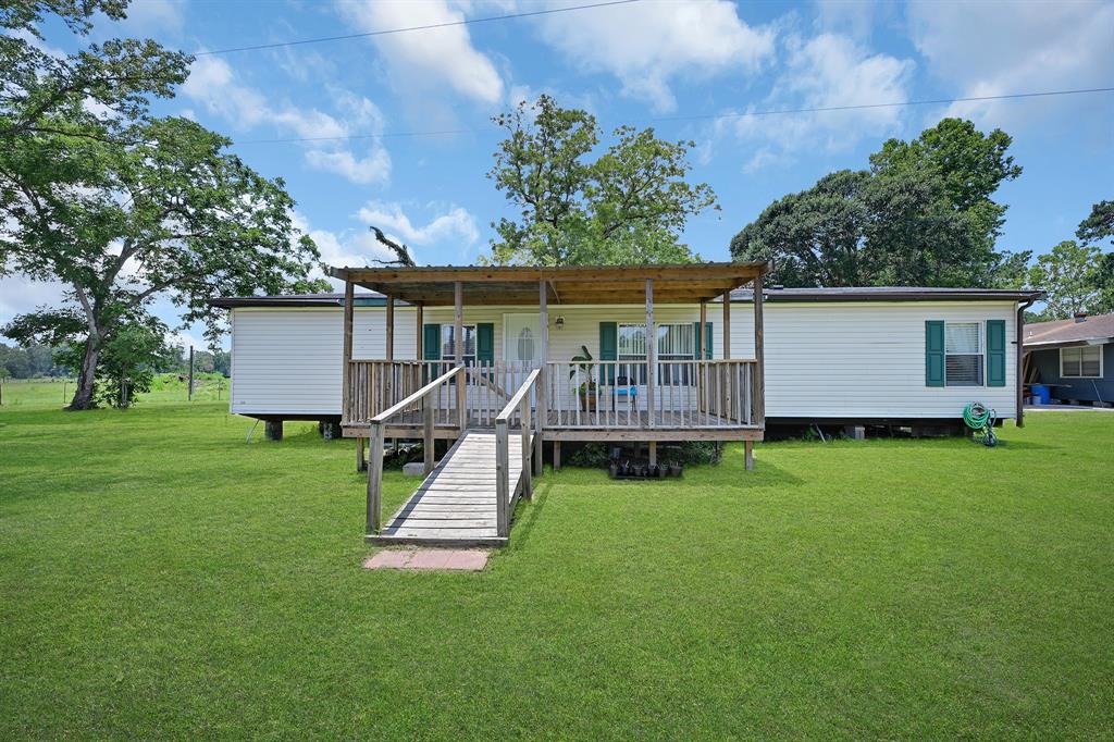 a view of a house with a yard table and chairs