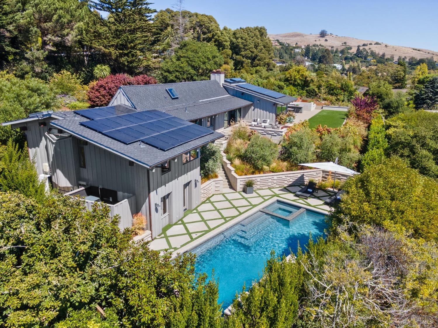 an aerial view of a house with swimming pool garden and patio