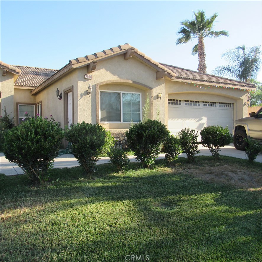 a front view of house with yard and outdoor seating