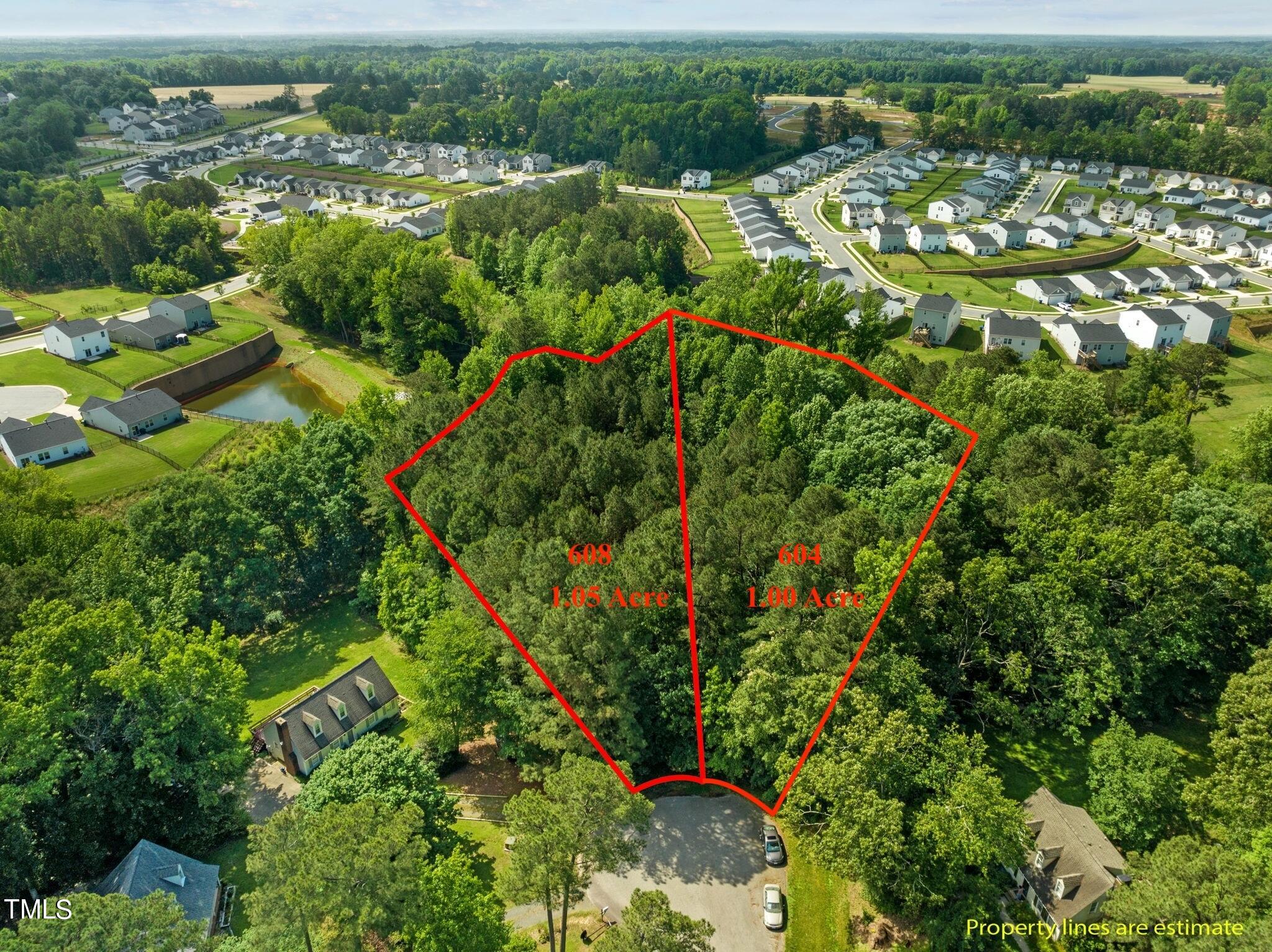 an aerial view of residential houses with outdoor space and trees