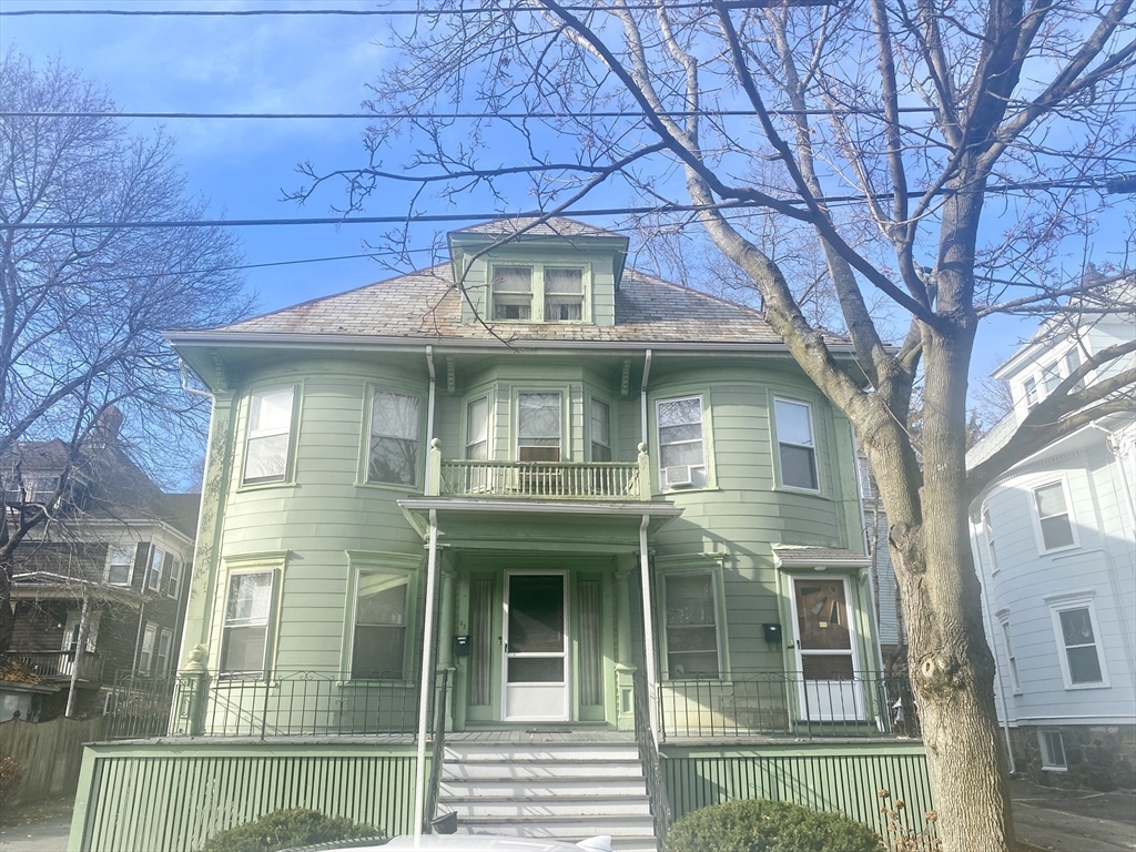 a front view of a house with a glass windows