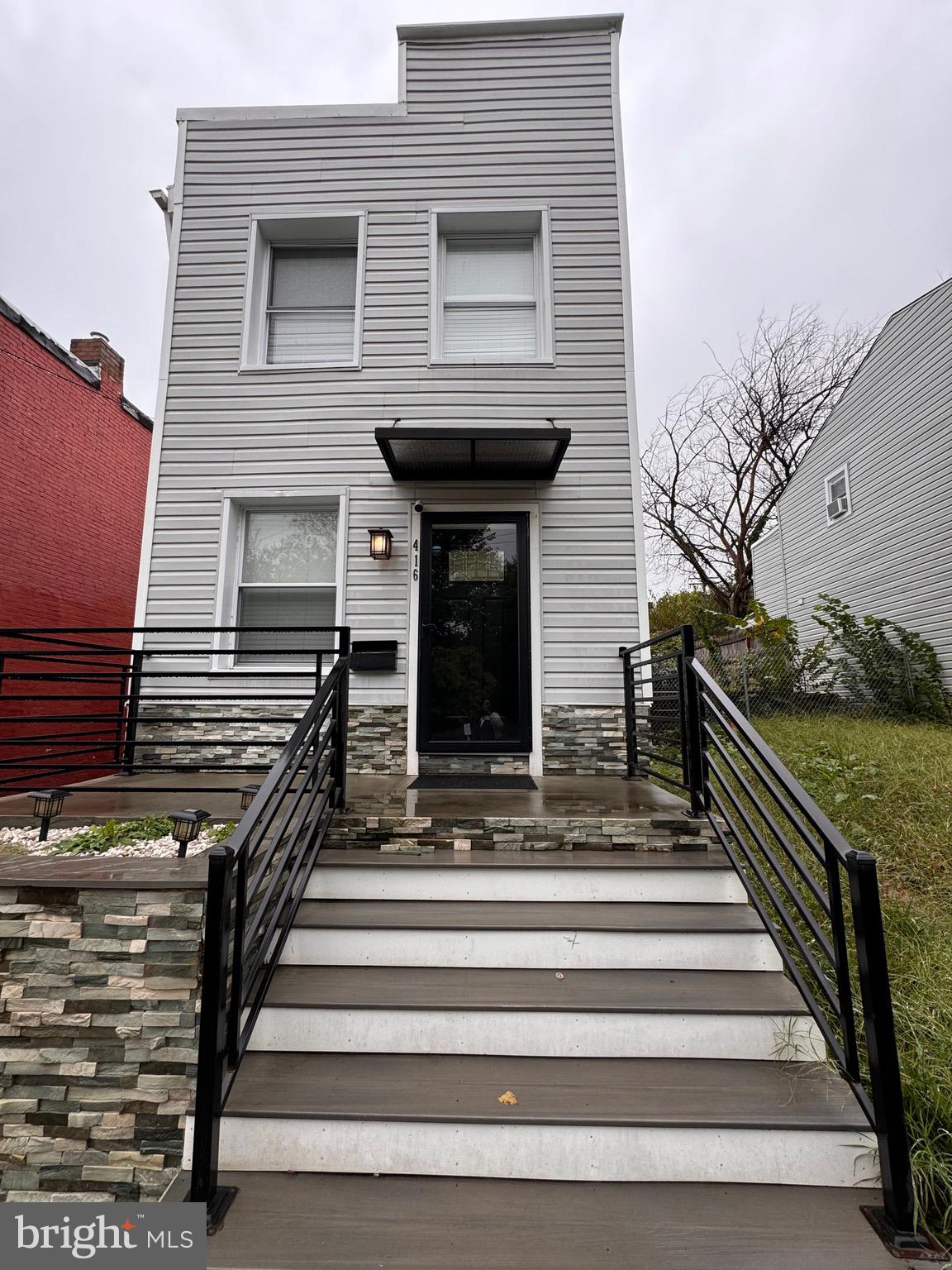 a front view of a house with stairs