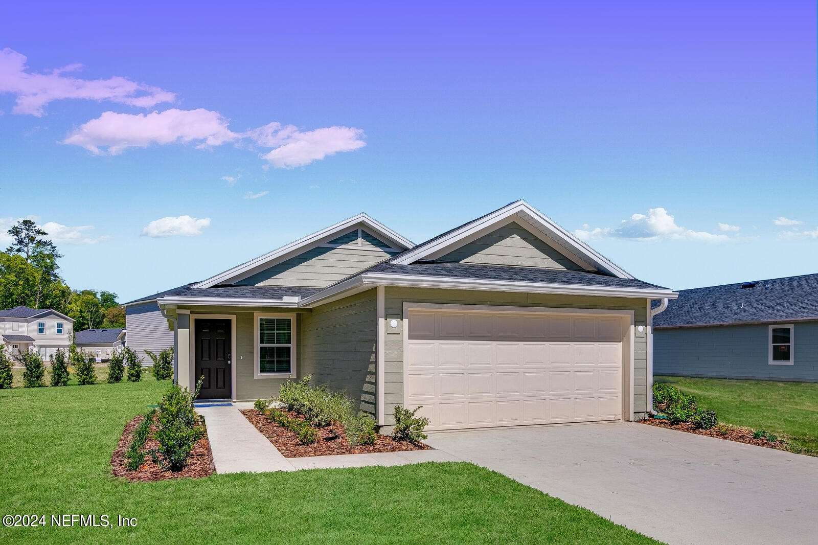 a front view of a house with a garden and yard