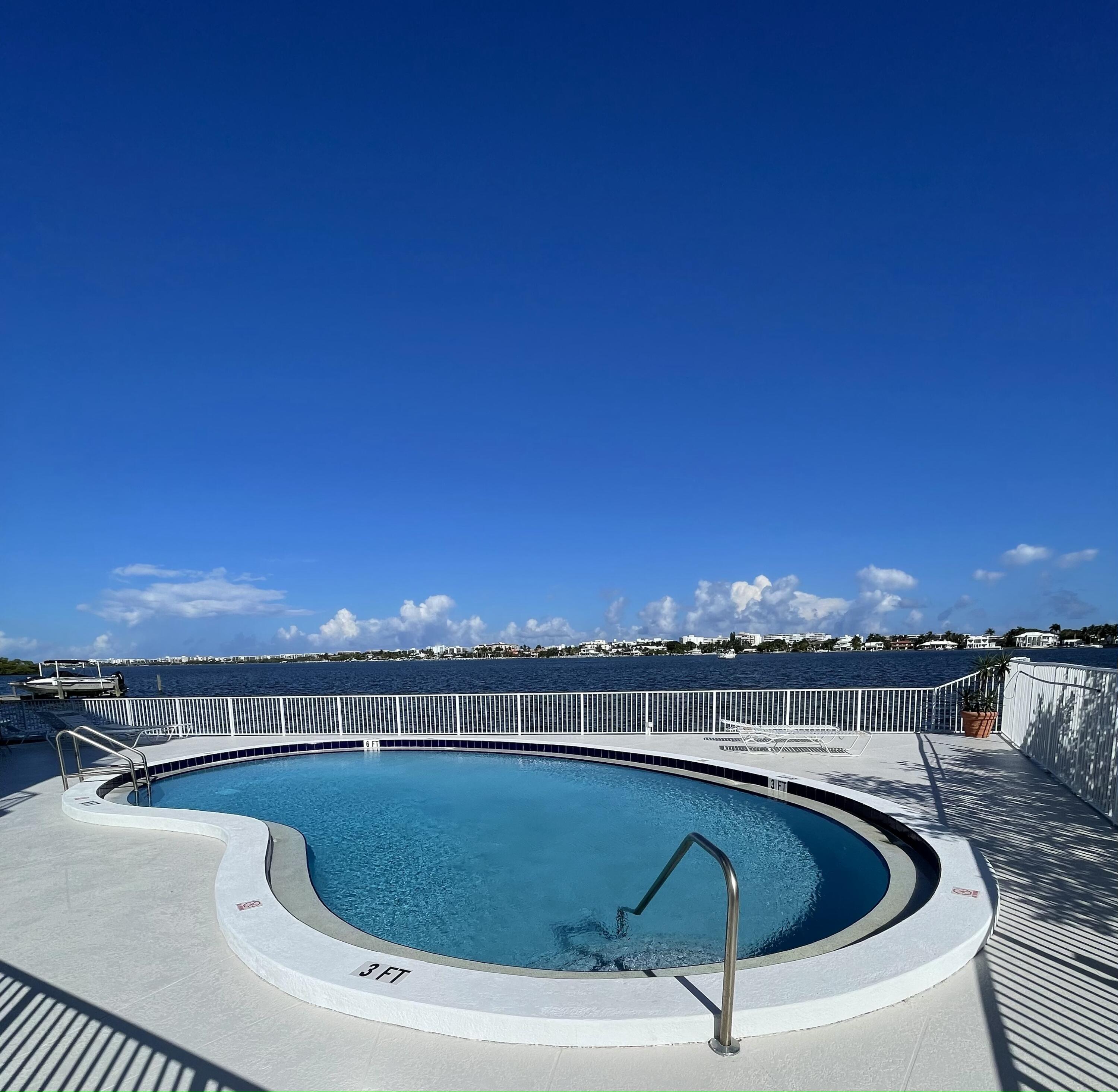 a view of a swimming pool and an outdoor seating