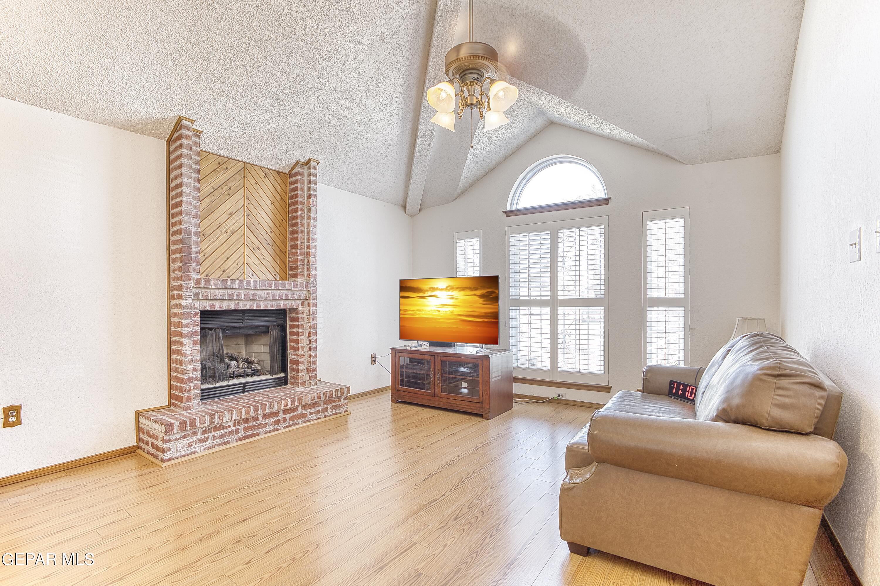 a living room with furniture flat screen tv and a fireplace