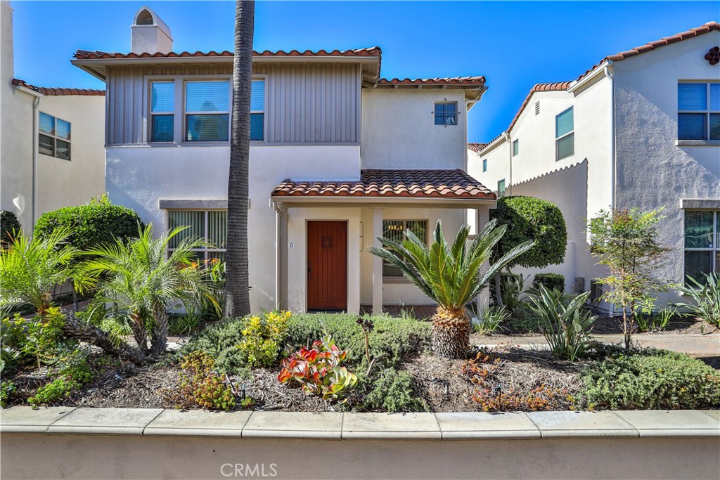 a front view of a house with lots of potted plants