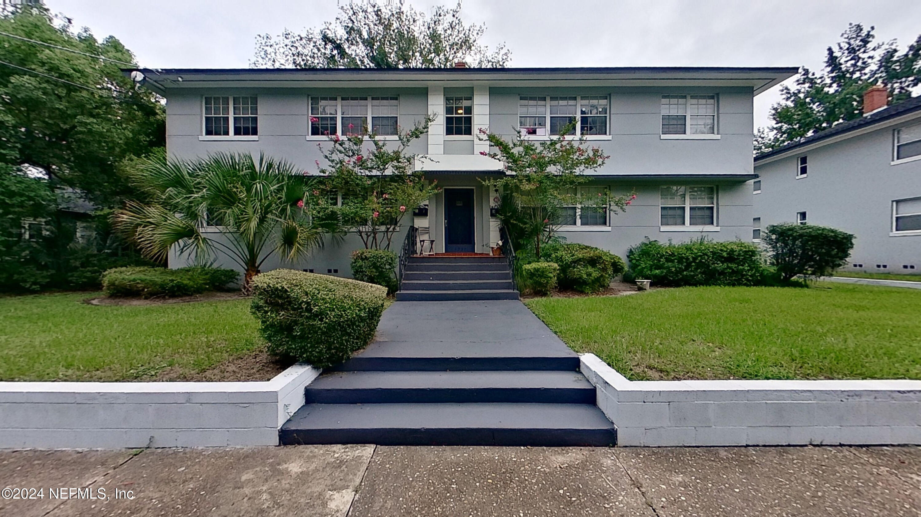 a front view of a house with garden