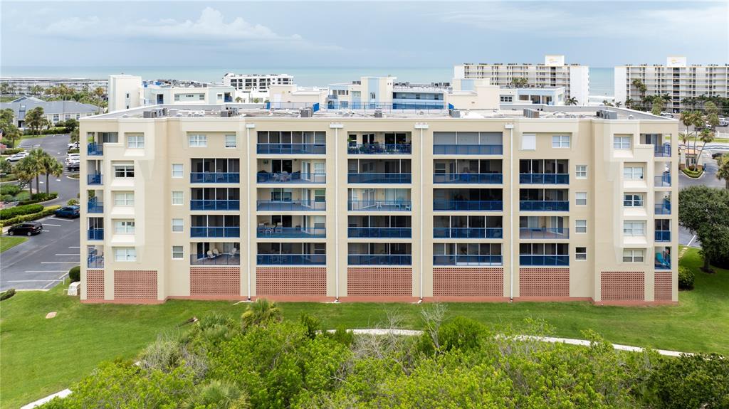 a view of front of a building with a yard