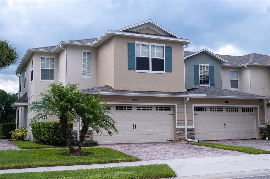 a front view of a house with a yard and garage