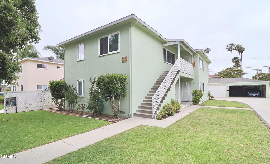 a view of a house with a yard and a deck