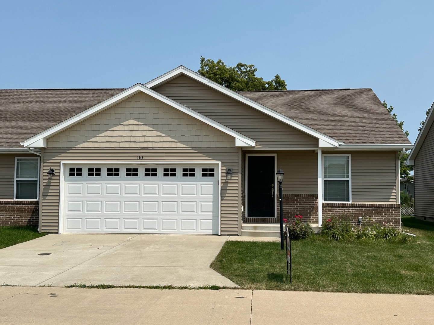 a front view of a house with a garden