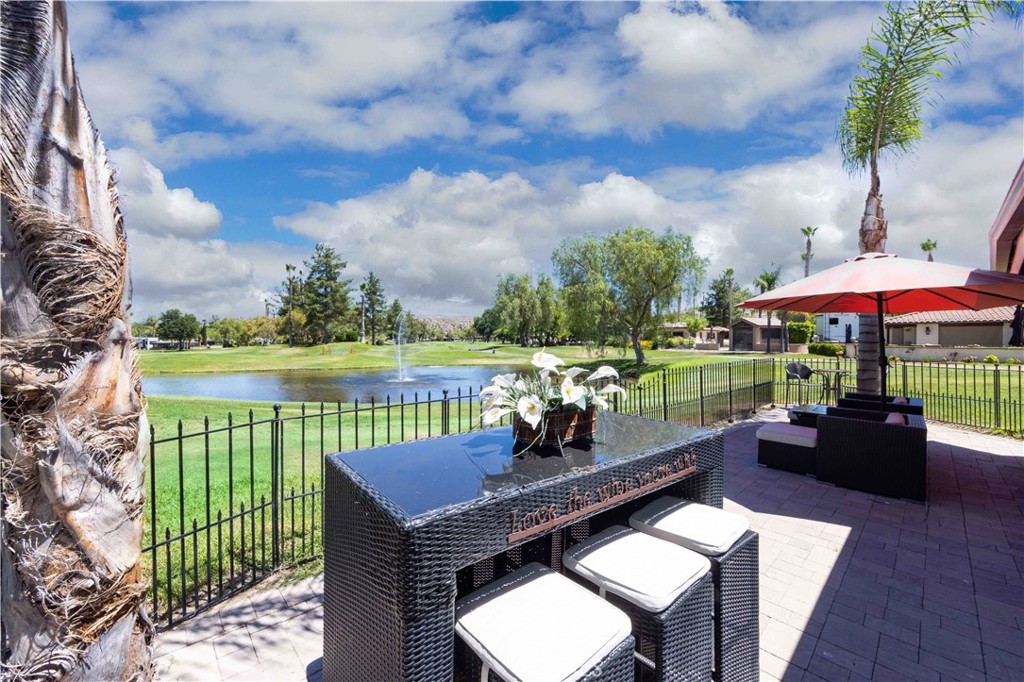 an outdoor sitting area with furniture and garden