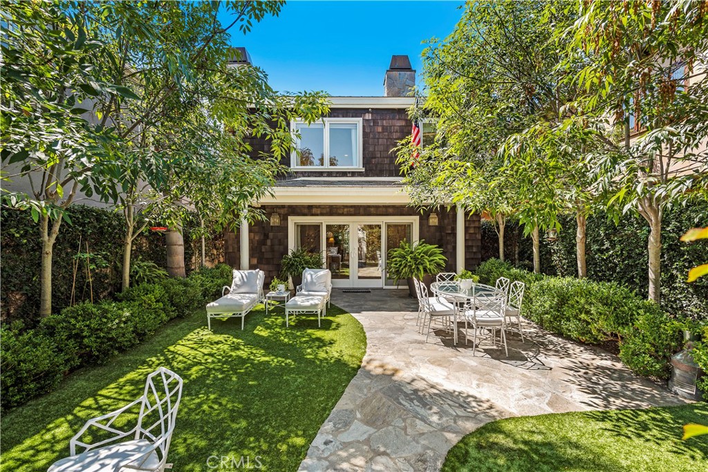 a view of a house with backyard sitting area and garden