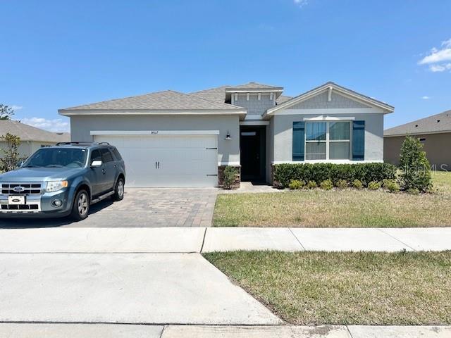 a front view of a house with a yard and garage