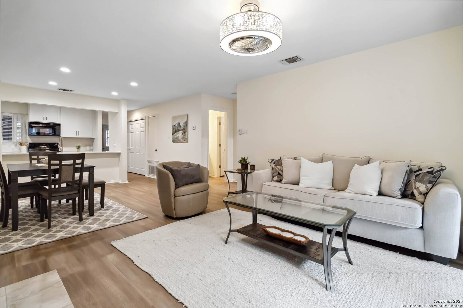 a living room with furniture and wooden floor