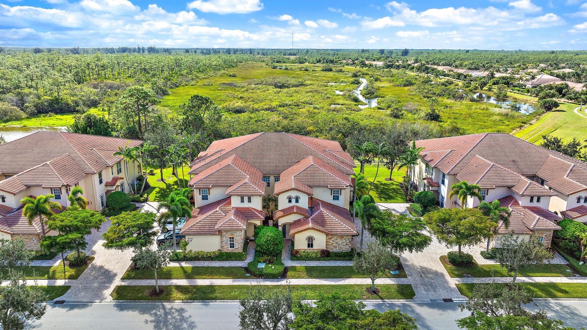 an aerial view of residential houses with outdoor space and lake view