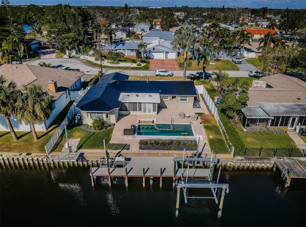 an aerial view of a house with outdoor space pool patio swimming pool and outdoor seating