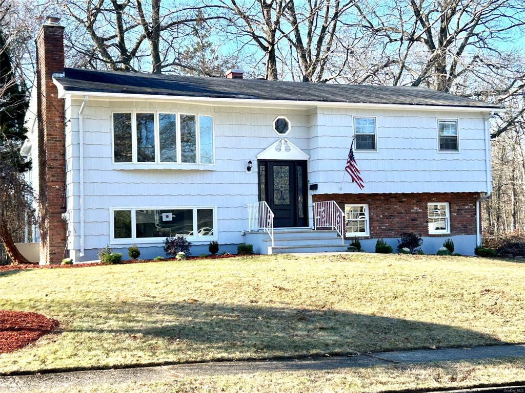 Split foyer home with a front yard