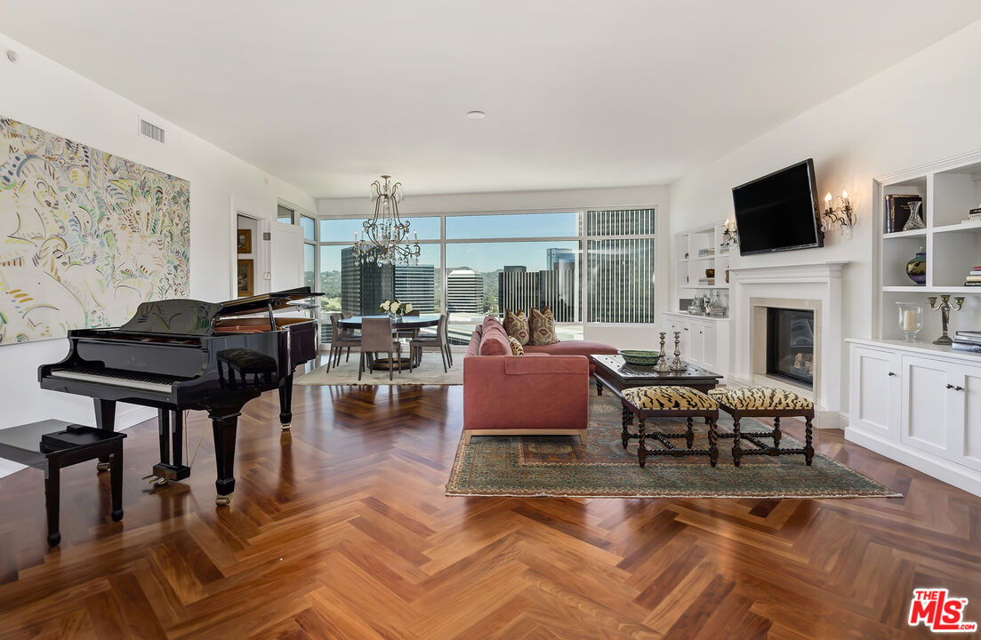 a living room with furniture fireplace and flat screen tv