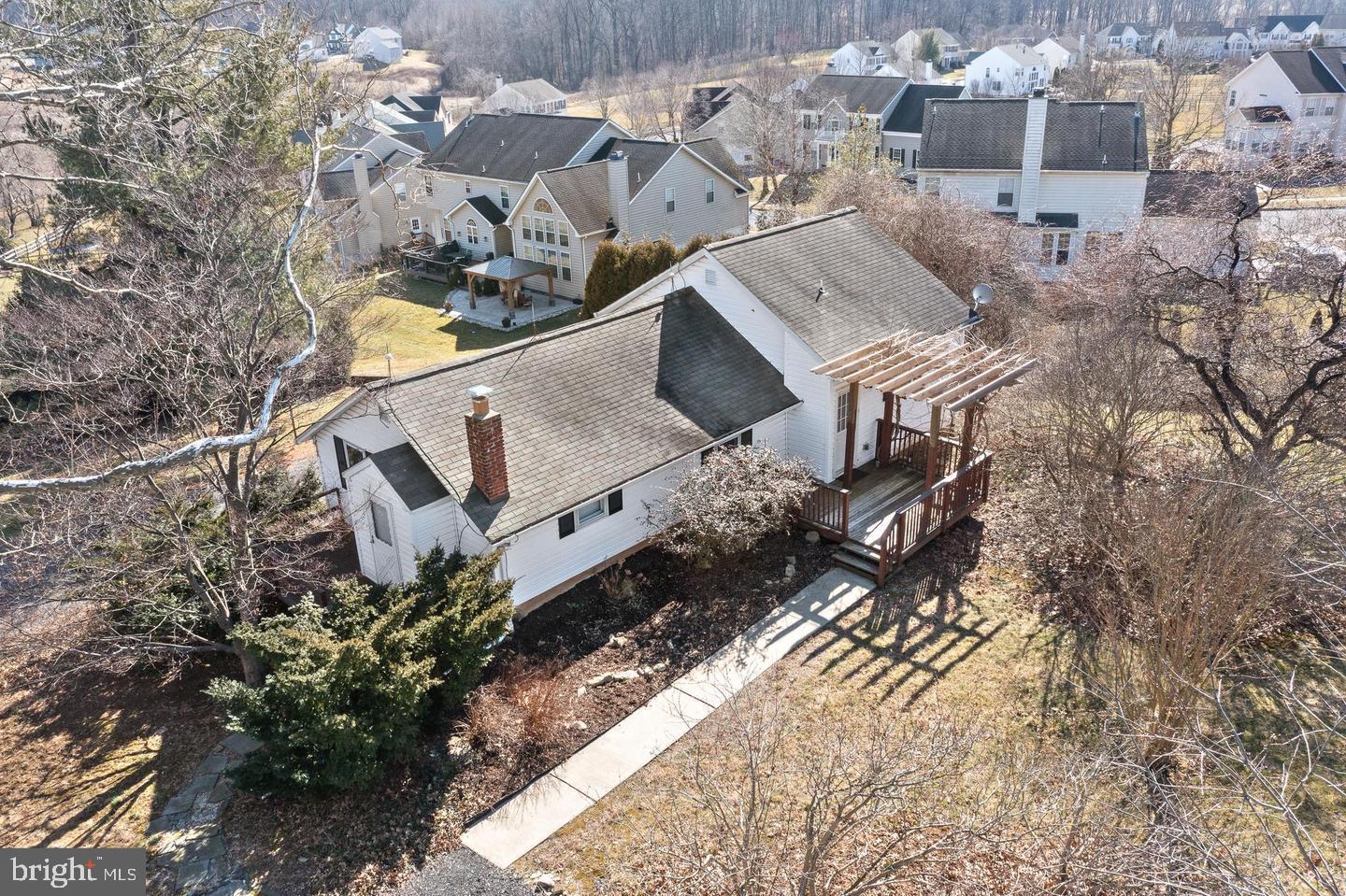 an aerial view of a house with a yard and lake view