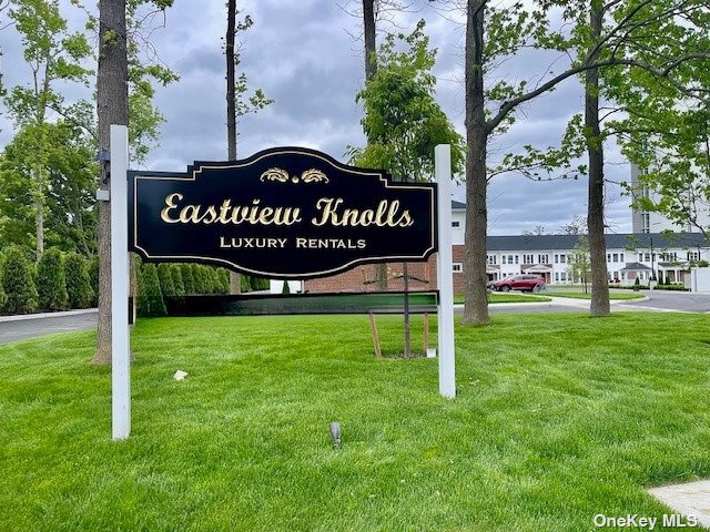 a view of a park that has a sign on the side of the road