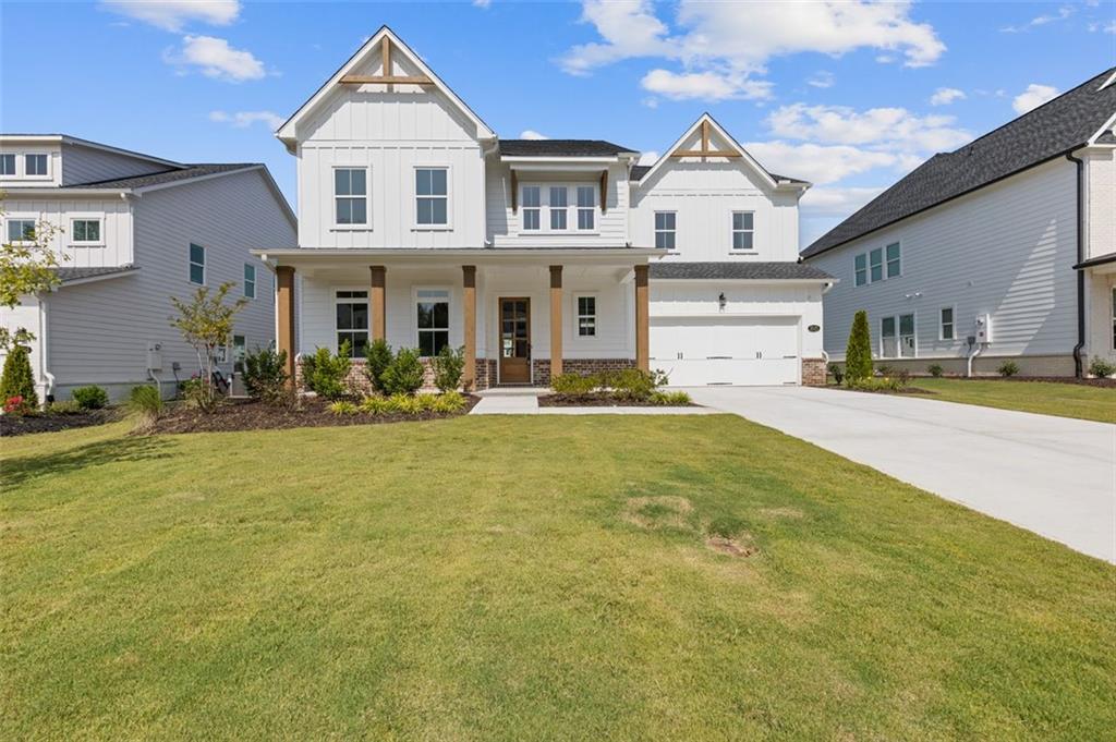 a front view of a house with lots of green space