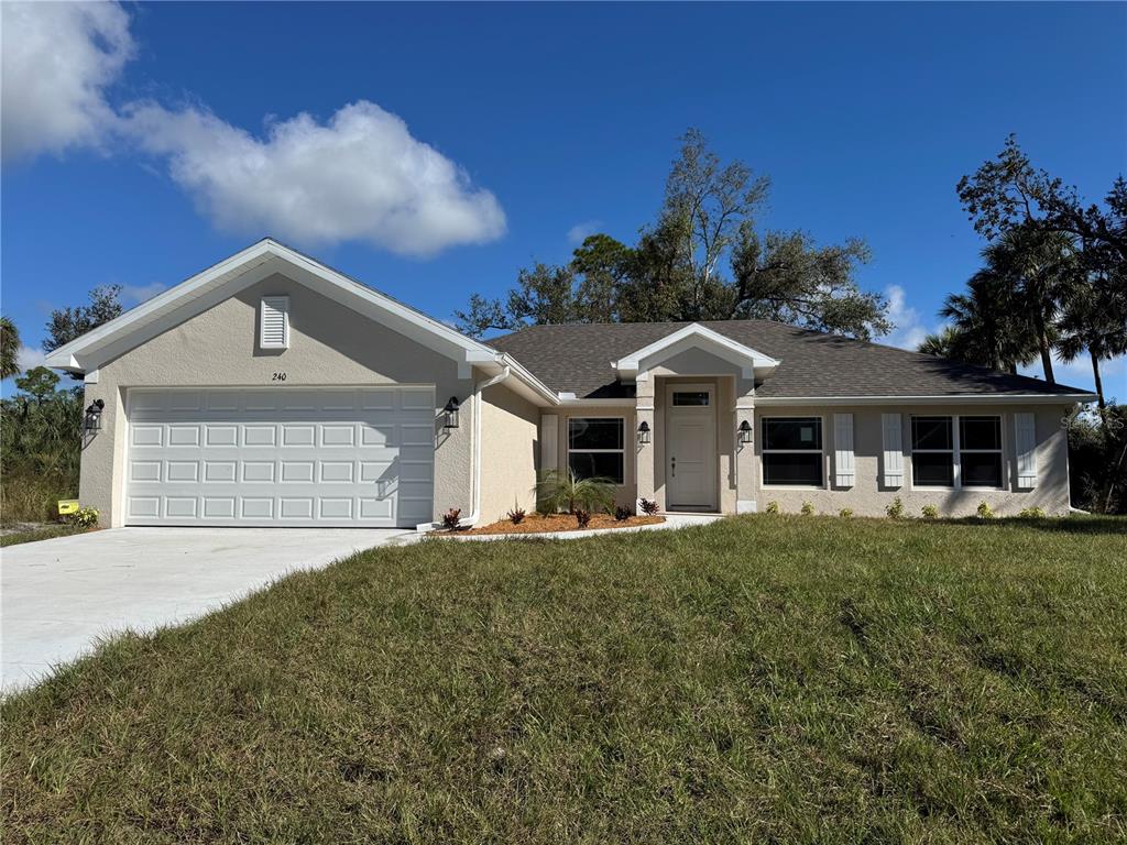 a front view of a house with a yard and garage