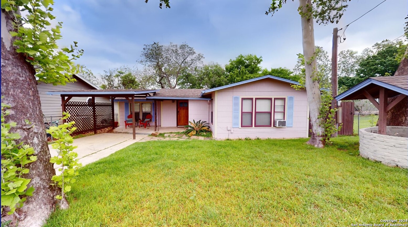 a view of a house with a yard and sitting area