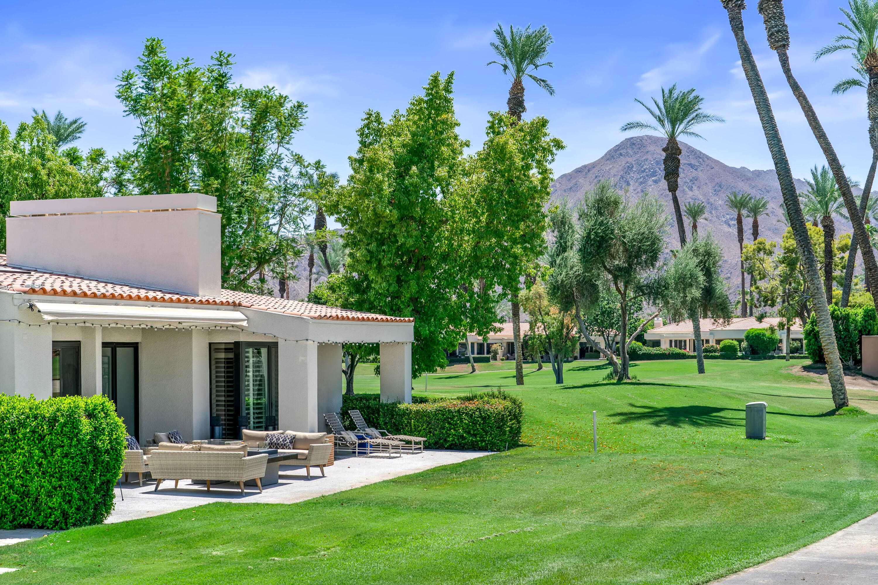 a view of a house with backyard sitting area and garden