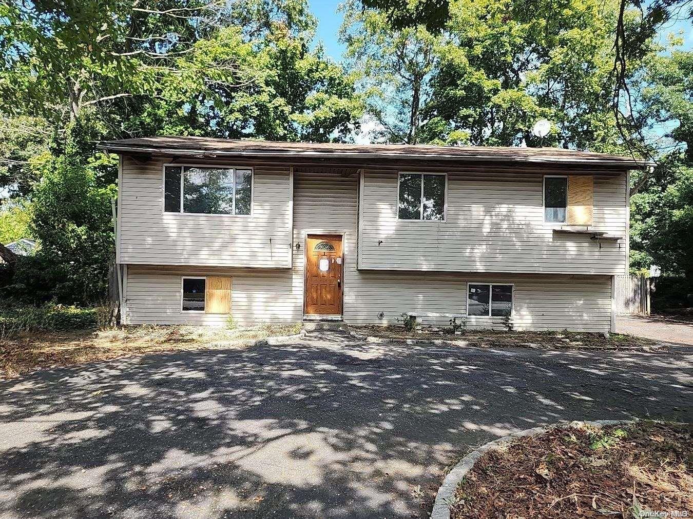 a front view of a house with trees