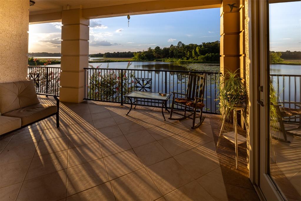 a view of a balcony with chairs and wooden floor